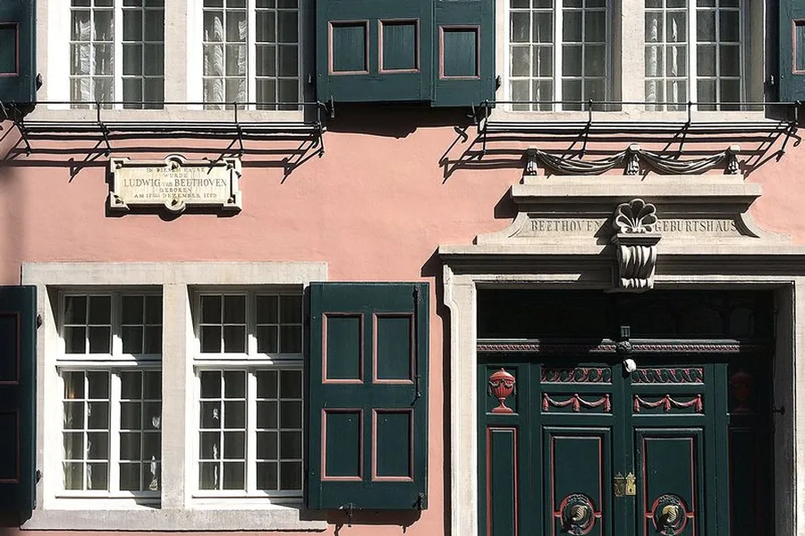 Street side of the Beethoven House museum with stone plaque above the ground floor: ‘Ludwig van Beethoven was born in this house on 17 December 1770’. Above the frieze of the double-door entrance portal is written: ‘Beethoven's birthplace’.